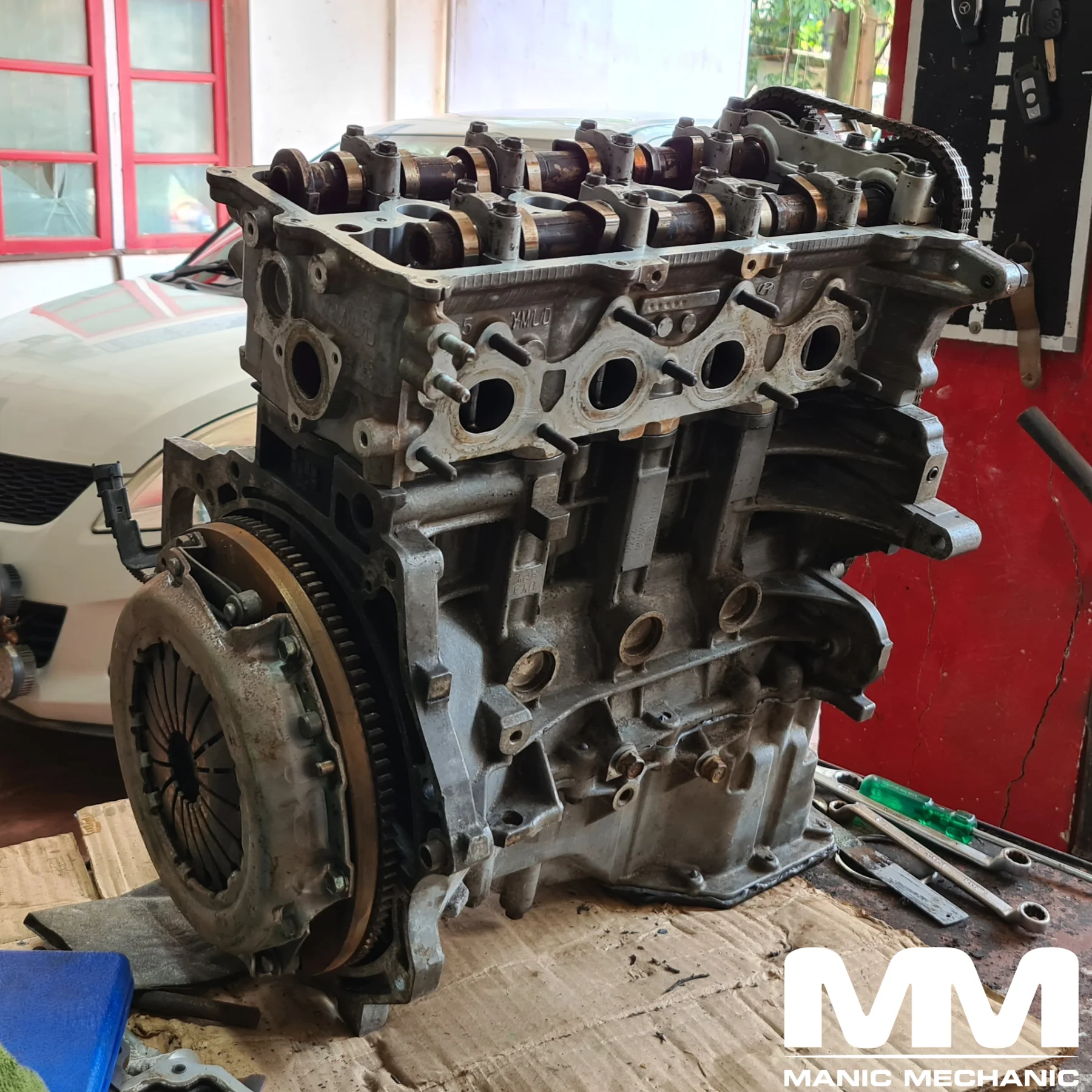Engine rebuild with removed engine and exposed cylinder head at Manic Mechanic Goa